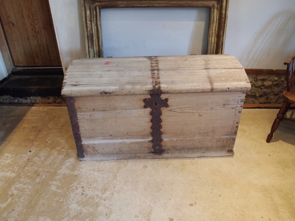 An eighteenth-century Scandinavian pine marriage chest featuring a domed lid, wrought iron corner brackets, and a central decorative iron escutcheon plate. View III