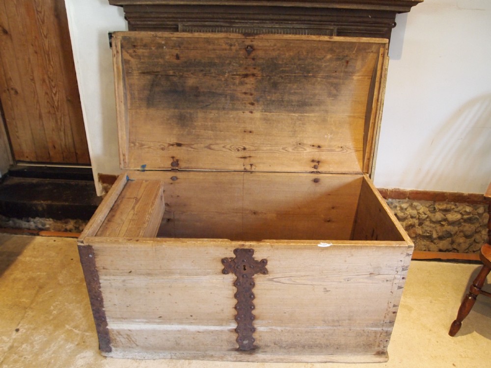 An eighteenth-century Scandinavian pine marriage chest featuring a domed lid, wrought iron corner brackets, and a central decorative iron escutcheon plate. View V