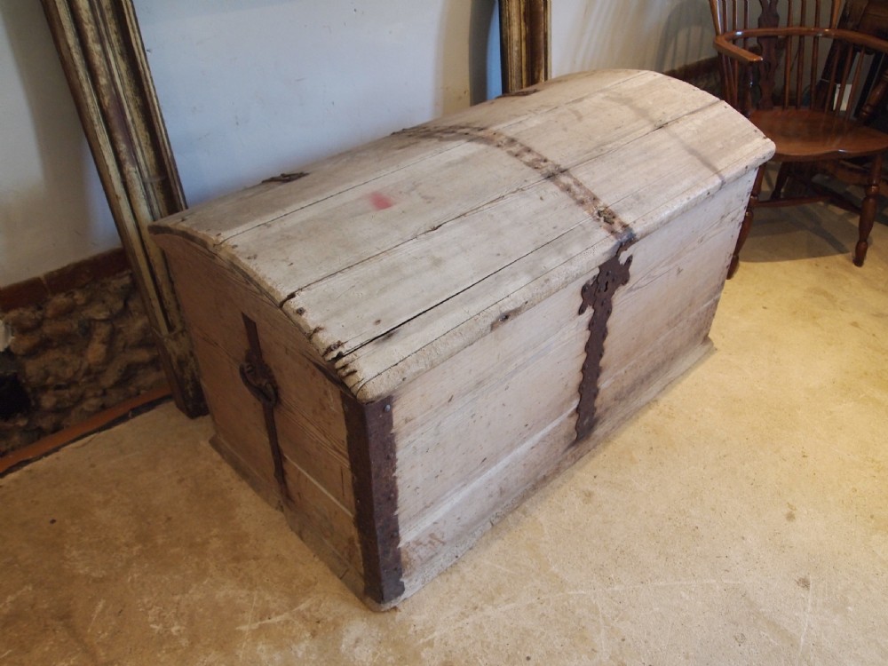 An eighteenth-century Scandinavian pine marriage chest featuring a domed lid, wrought iron corner brackets, and a central decorative iron escutcheon plate. View IX