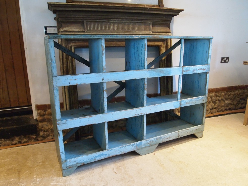 A late 19th-century open wooden storage unit featuring twelve cubby compartments finished in distressed light blue paint. View II