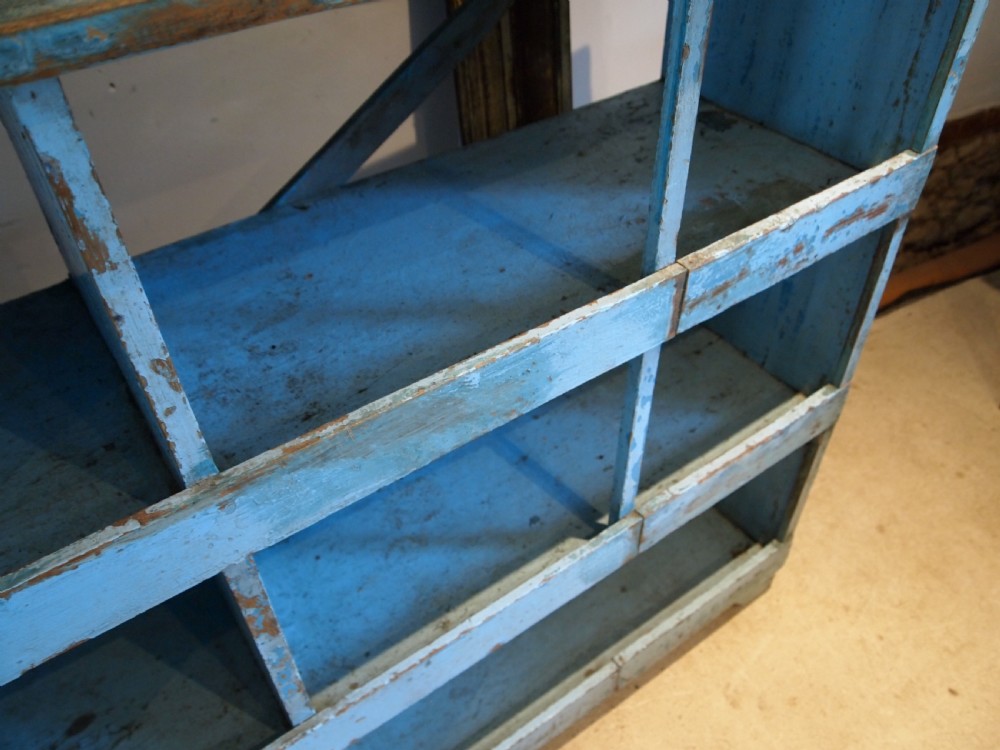 A late 19th-century open wooden storage unit featuring twelve cubby compartments finished in distressed light blue paint. View VII