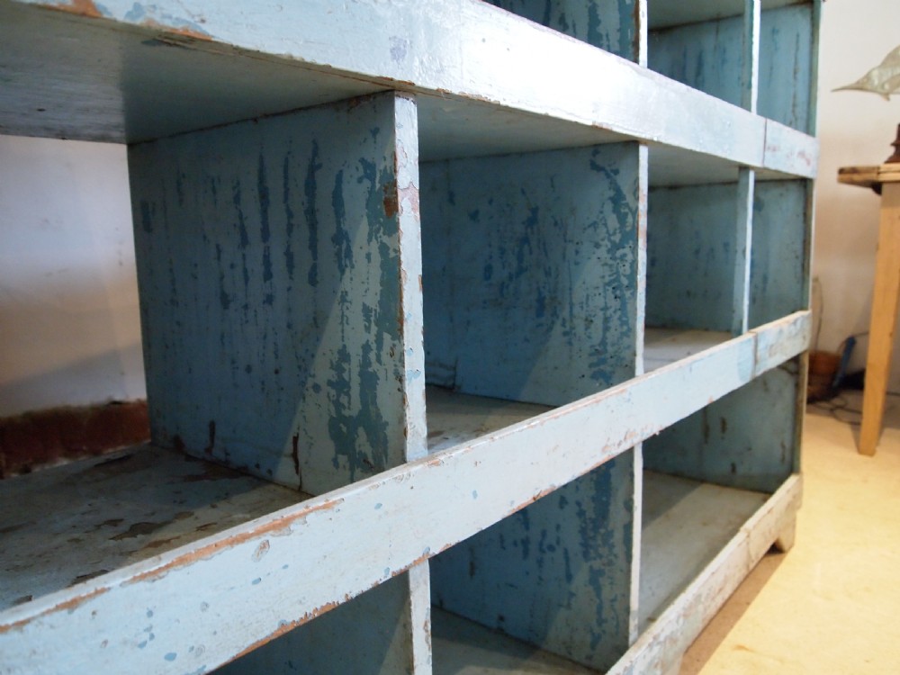 A late 19th-century open wooden storage unit featuring twelve cubby compartments finished in distressed light blue paint. View VIII