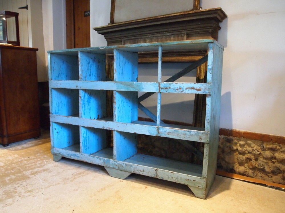 A late 19th-century open wooden storage unit featuring twelve cubby compartments finished in distressed light blue paint. View IX