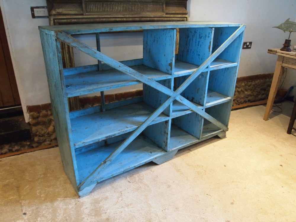 A late 19th-century open wooden storage unit featuring twelve cubby compartments finished in distressed light blue paint. View XI
