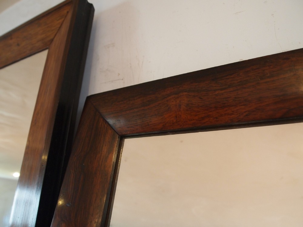 A trio of rectangular Regency period mirrors featuring dark rosewood frames with wide moulded borders. View II