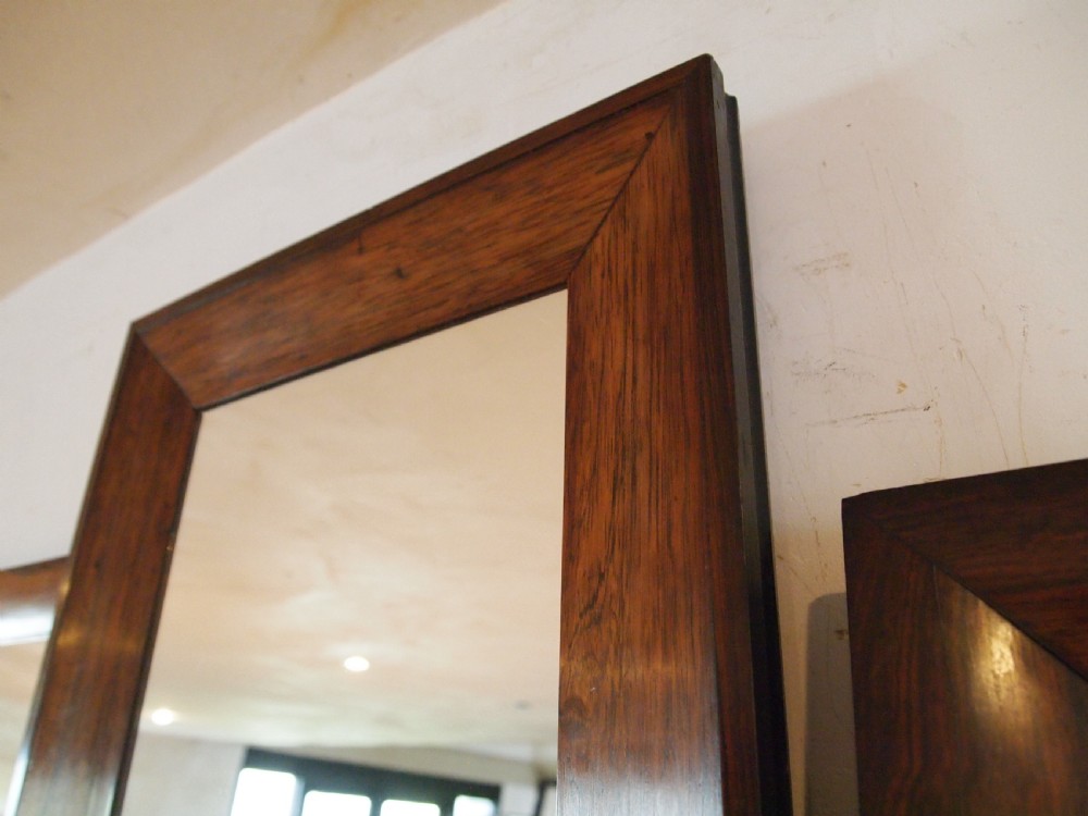 A trio of rectangular Regency period mirrors featuring dark rosewood frames with wide moulded borders. View III