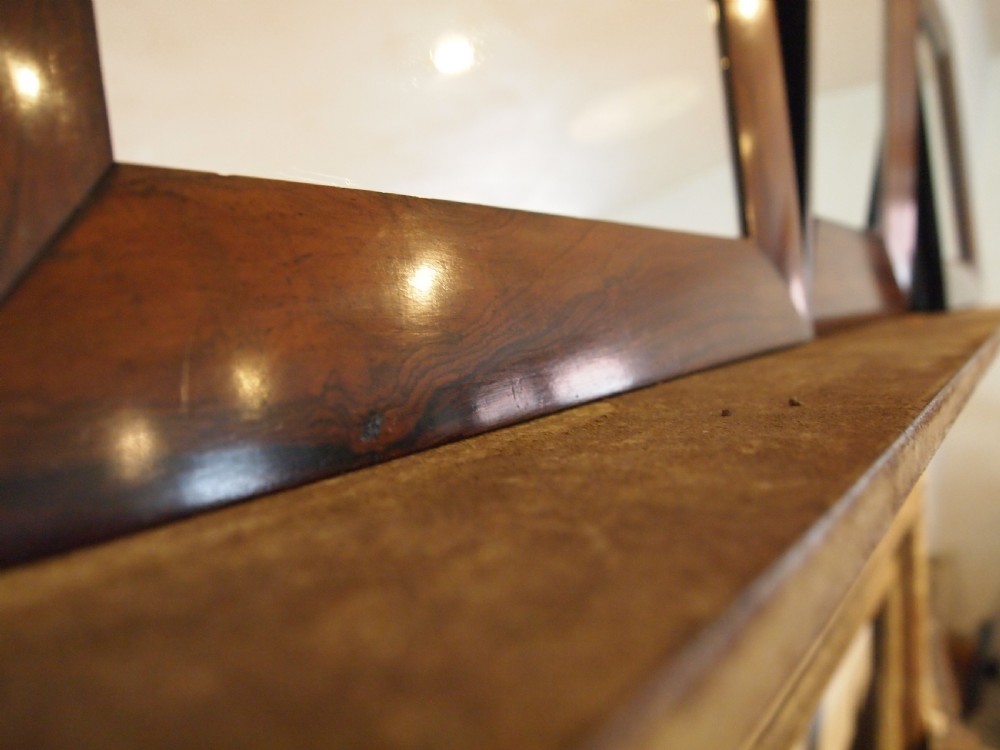 A trio of rectangular Regency period mirrors featuring dark rosewood frames with wide moulded borders. View VI
