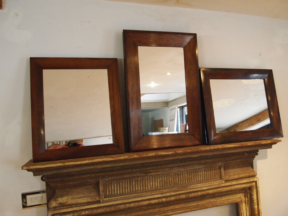 A trio of rectangular Regency period mirrors featuring dark rosewood frames with wide moulded borders. View XI