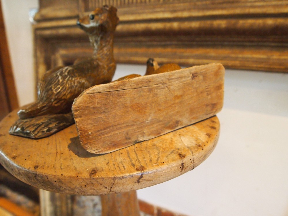 A pair of hand-carved limewood fawns in recumbent poses with detailed carved fur on integral wooden bases. View VI