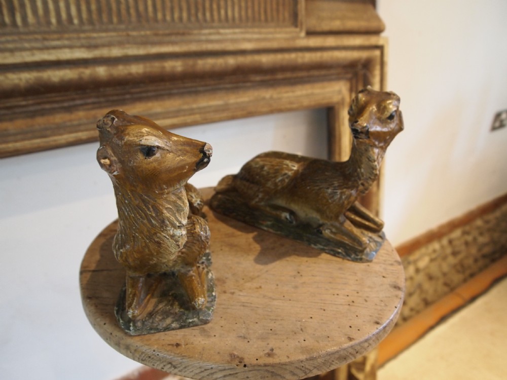 A pair of hand-carved limewood fawns in recumbent poses with detailed carved fur on integral wooden bases. View VIII