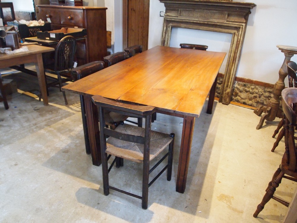 A 19th-century French cherry wood refectory dining table with a plank top and fluted square legs. View II