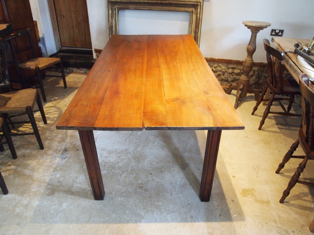 A 19th-century French cherry wood refectory dining table with a plank top and fluted square legs. View III