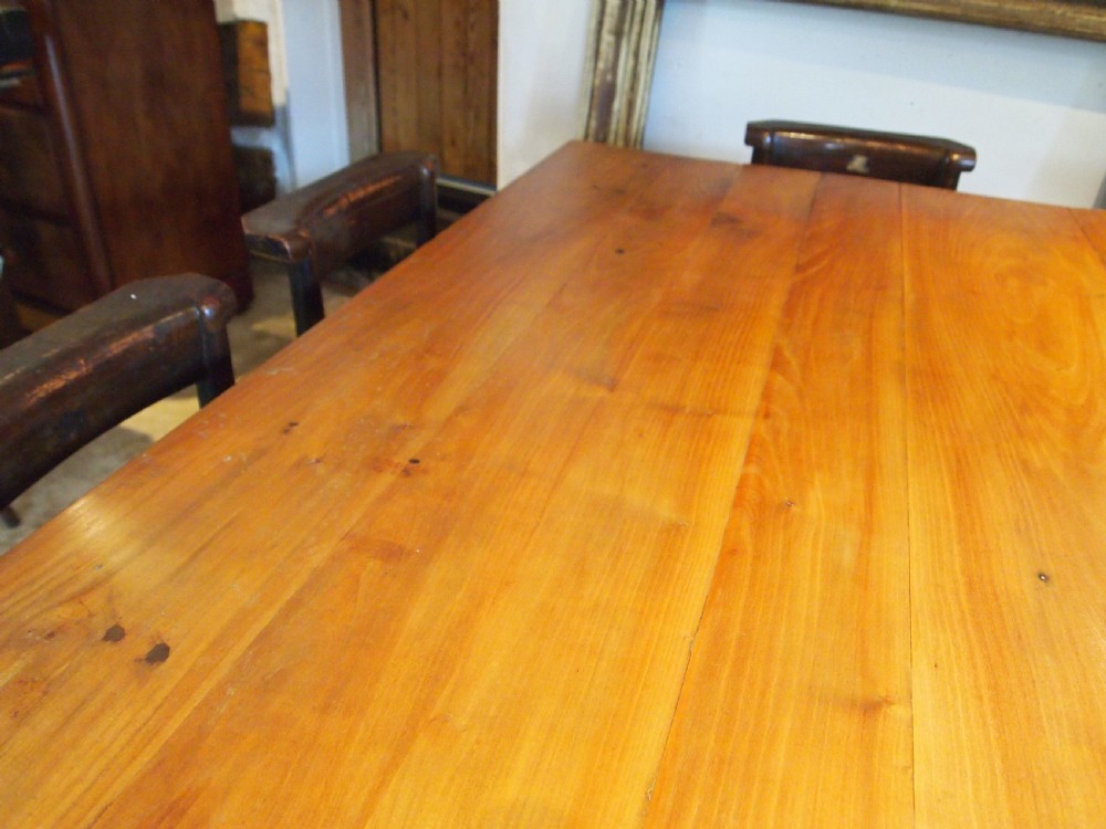A 19th-century French cherry wood refectory dining table with a plank top and fluted square legs. View IV