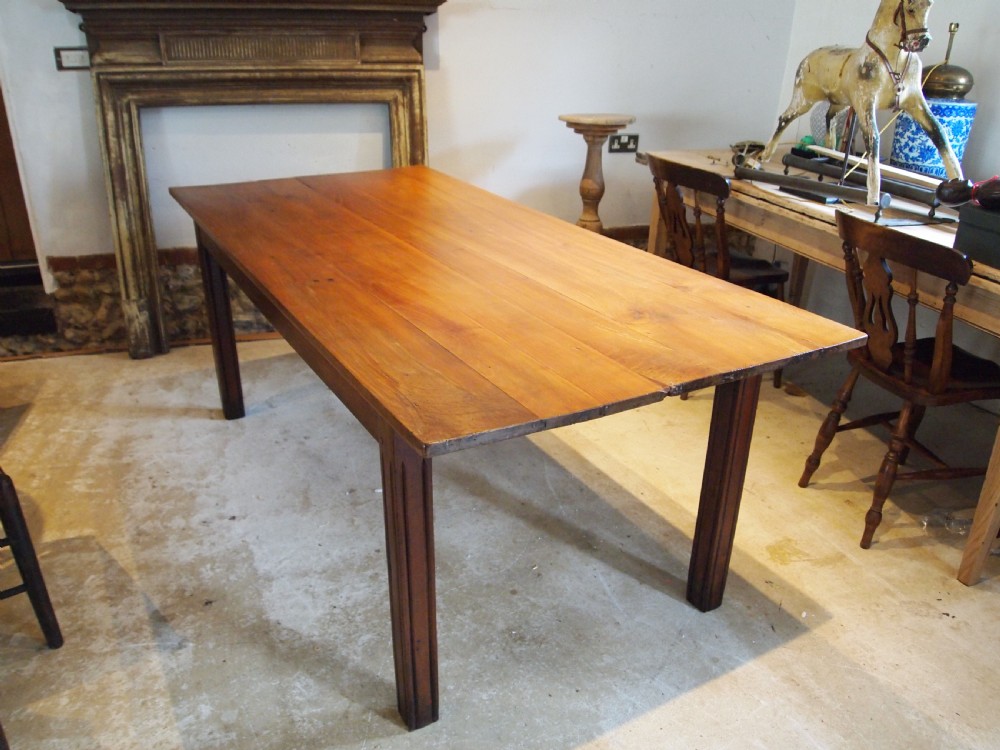 A 19th-century French cherry wood refectory dining table with a plank top and fluted square legs. View VIII