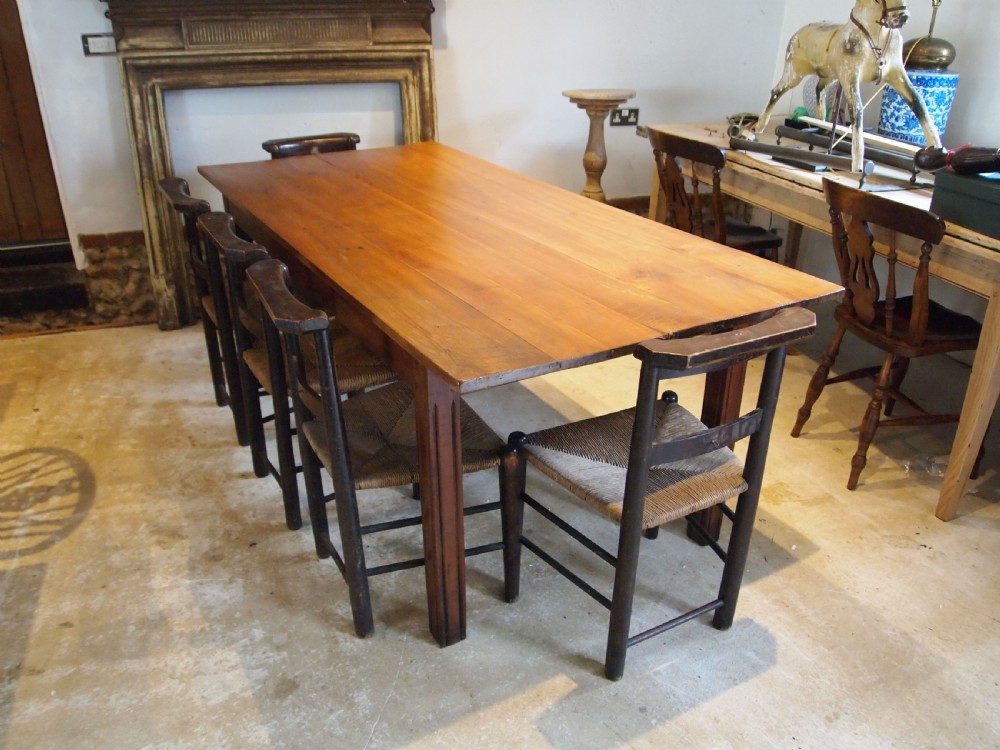 A 19th-century French cherry wood refectory dining table with a plank top and fluted square legs. View XI