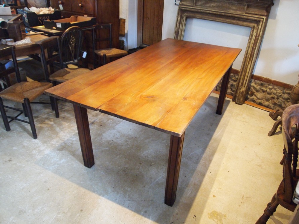 A 19th-century French cherry wood refectory dining table with a plank top and fluted square legs. View XII