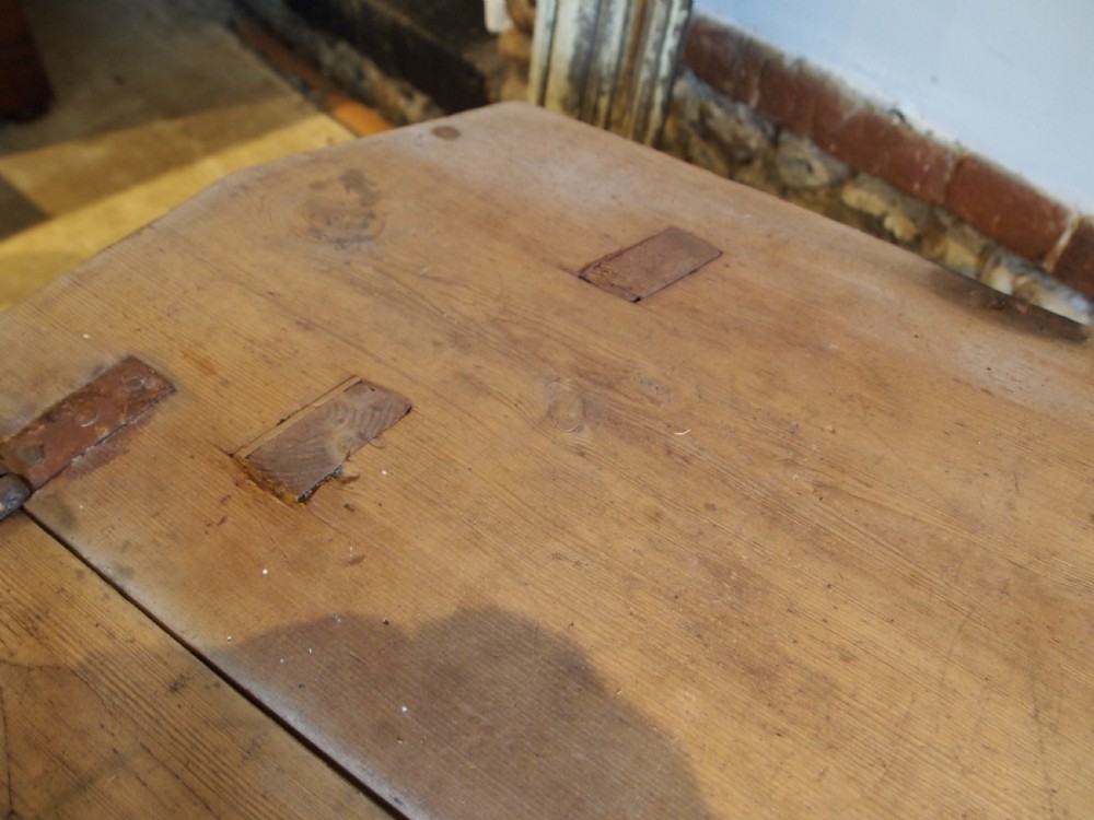 A George III primitive pine chair table featuring a tall central wooden backboard splat, flat bench seat, iron hinges, and four splayed round legs. View VI
