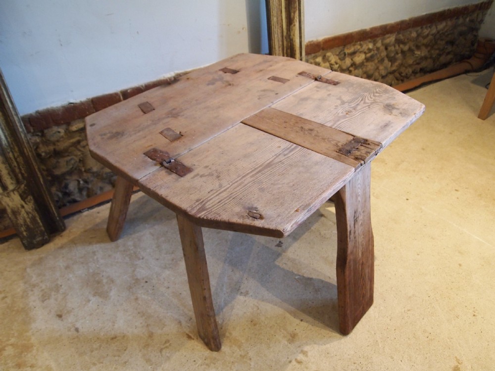 A George III primitive pine chair table featuring a tall central wooden backboard splat, flat bench seat, iron hinges, and four splayed round legs. View VII