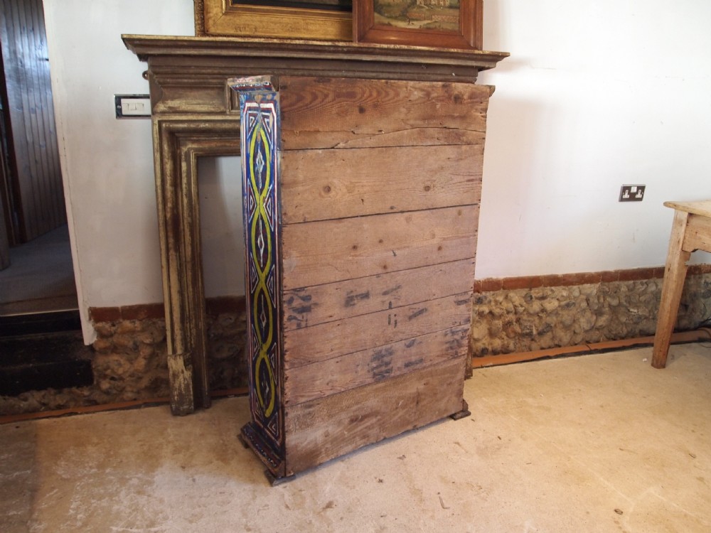 A Victorian pine single-door cupboard decorated with vibrant hand-painted blue, yellow, red, and white geometric folk art motifs. View VII