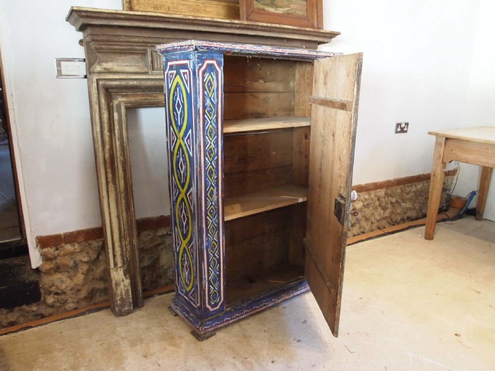 A Victorian pine single-door cupboard decorated with vibrant hand-painted blue, yellow, red, and white geometric folk art motifs. View XI