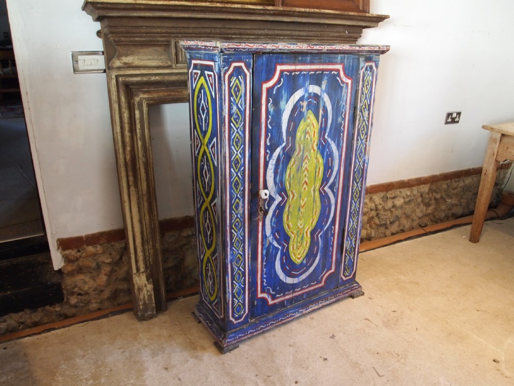 A Victorian pine single-door cupboard decorated with vibrant hand-painted blue, yellow, red, and white geometric folk art motifs. View XIII