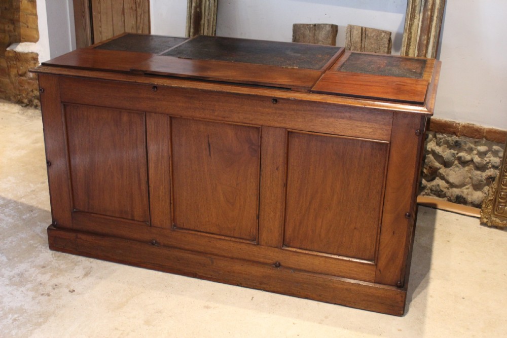 A Victorian mahogany pedestal desk fitted with a central hinged writing slope, leather top inserts, and graduated drawers with turned wooden handles. View VIII
