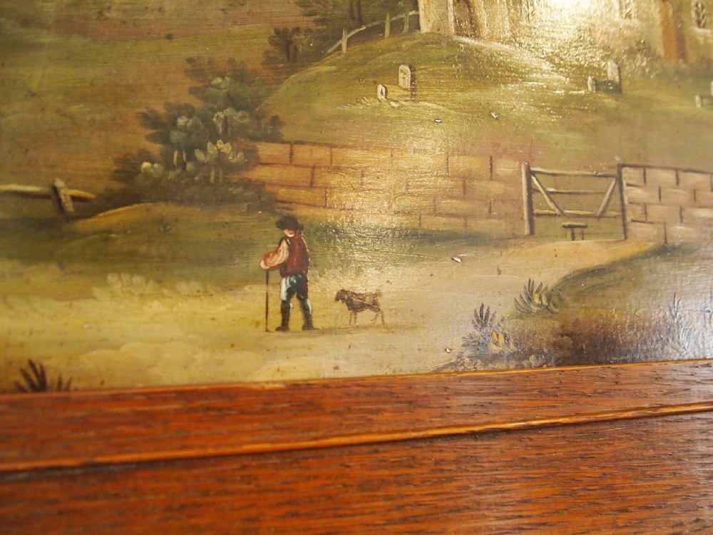A 19th-century naive oil painting on board depicting a rural church scene with a figure walking a dog, set within a wide wooden frame. View X