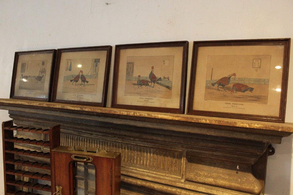 A set of four framed Victorian aquatint prints depicting cockfighting scenes in matching dark wood frames. View VIII