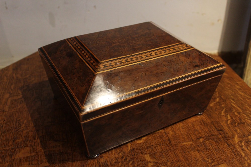 A nineteenth-century Regency period burr yew wooden jewellery box with geometric marquetry banding and a diamond escutcheon.