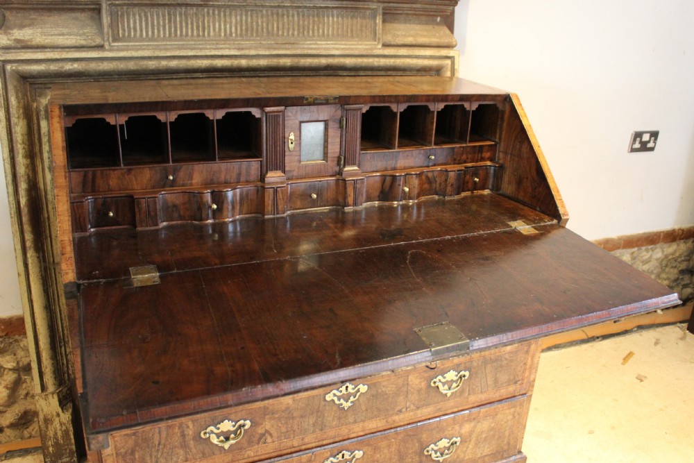 A George II walnut bureau featuring a slanted fall-front flap over four graduated drawers with brass handles, resting on bracket feet. View VI