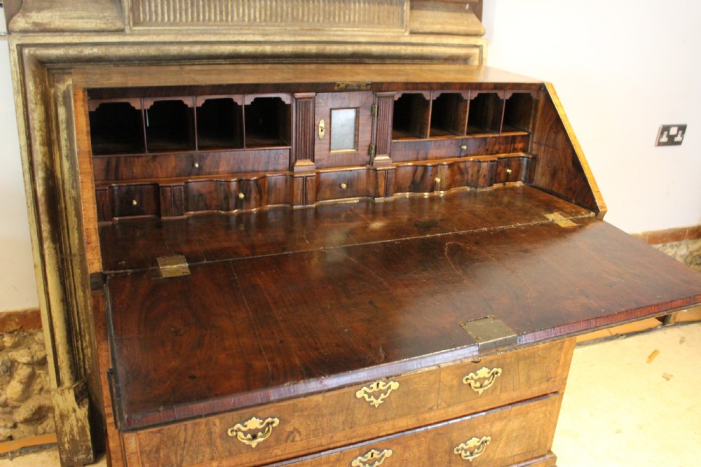 A George II walnut bureau featuring a slanted fall-front flap over four graduated drawers with brass handles, resting on bracket feet. View XVIII