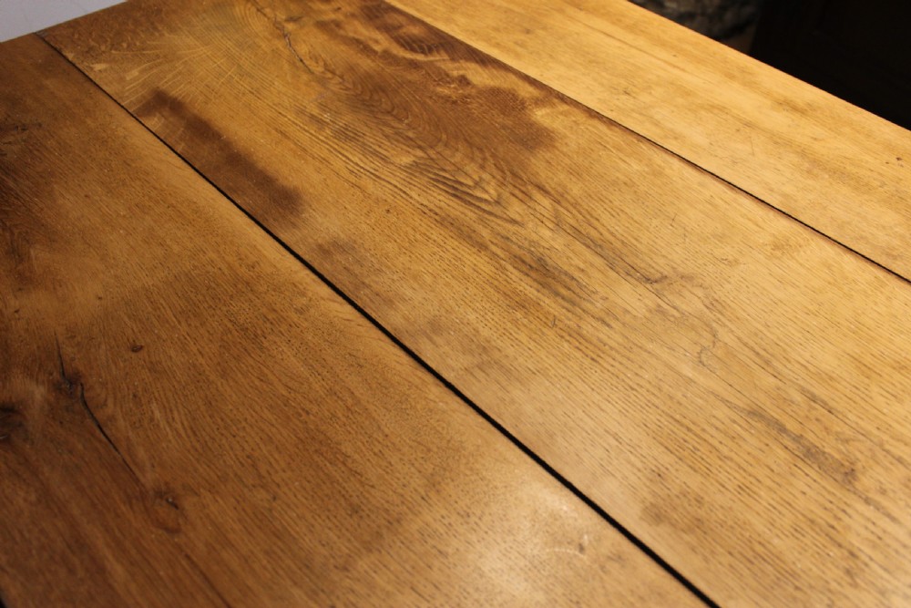 A rectangular Victorian solid oak refectory dining table with a plank top and tapered square legs. View VI