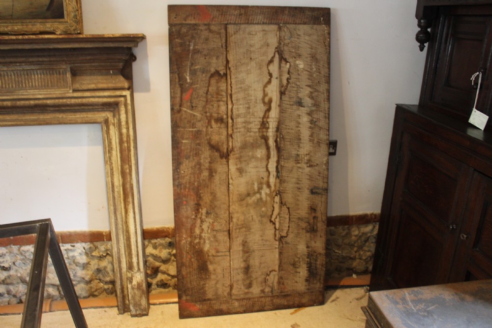 An antique George III oak plank table top with a warm brown patina mounted on a modern dark metal trapezoidal frame. View IV