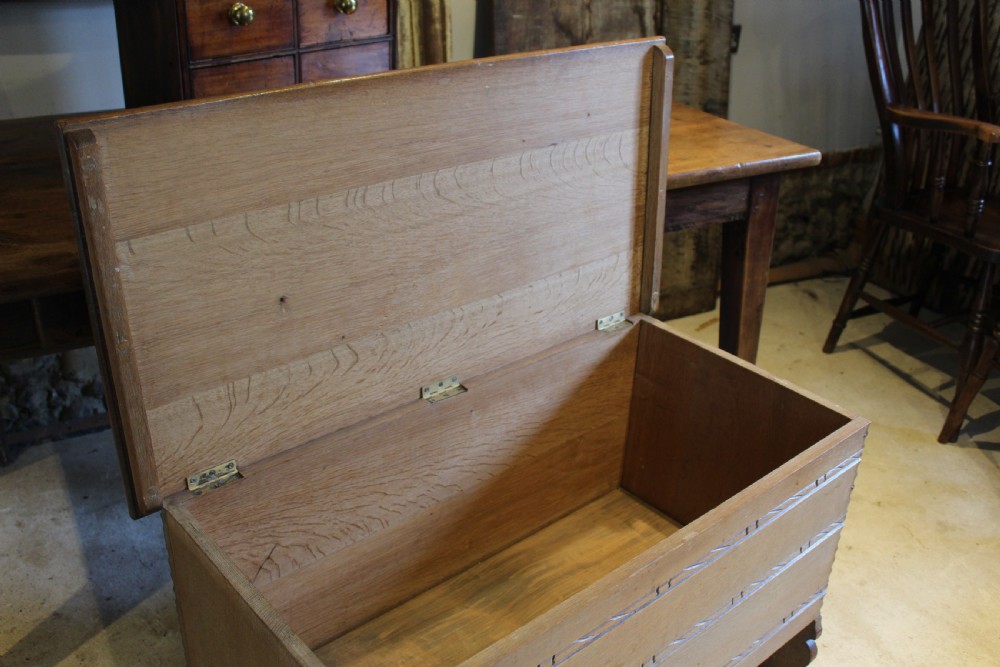 A 1930s limed oak coffer chest with carved horizontal rope twist detailing and cutout slab end feet. View III