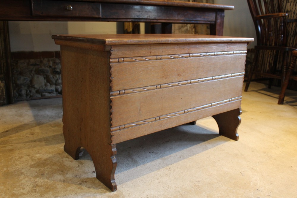 A 1930s limed oak coffer chest with carved horizontal rope twist detailing and cutout slab end feet. View VIII