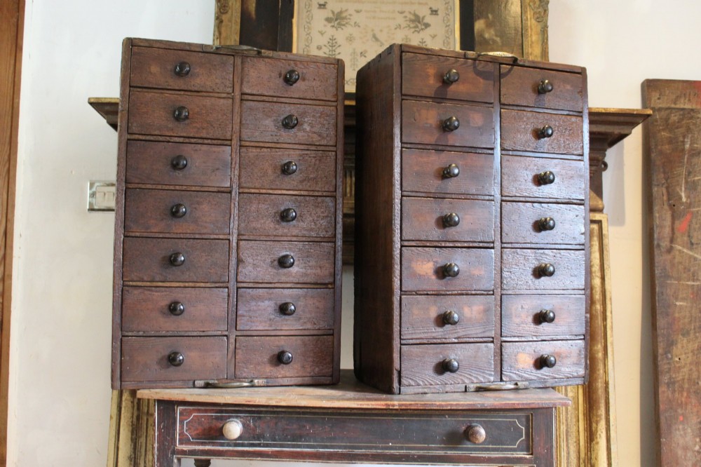 A pair of dark brown Victorian pine specimen cabinets, each featuring twin columns of eight small drawers fitted with turned wooden handles. View VI