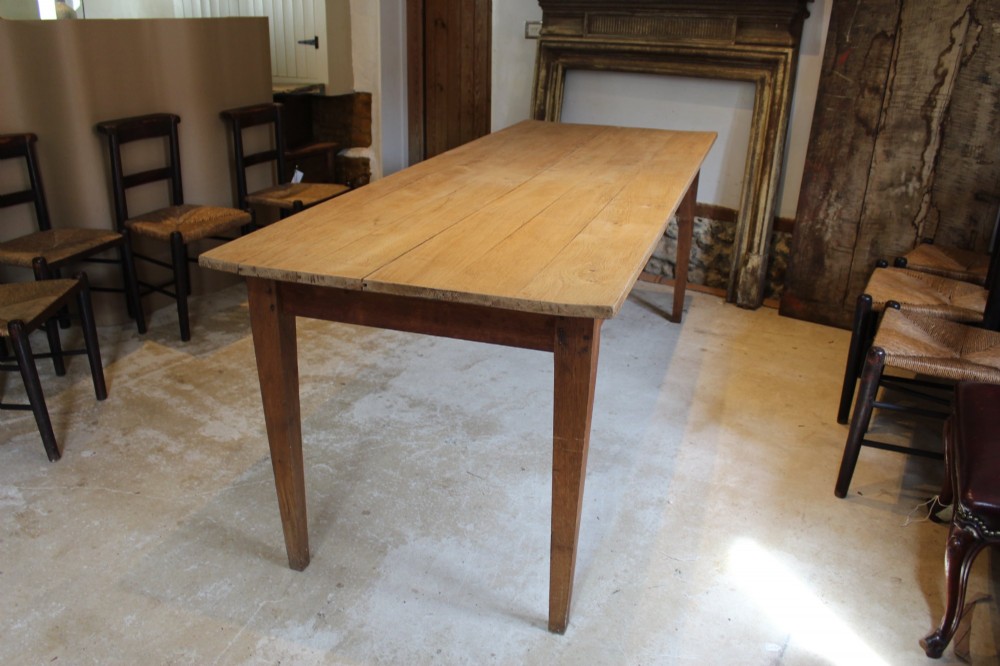 A long antique oak refectory dining table featuring a planked wood top and four square tapered legs. View VIII