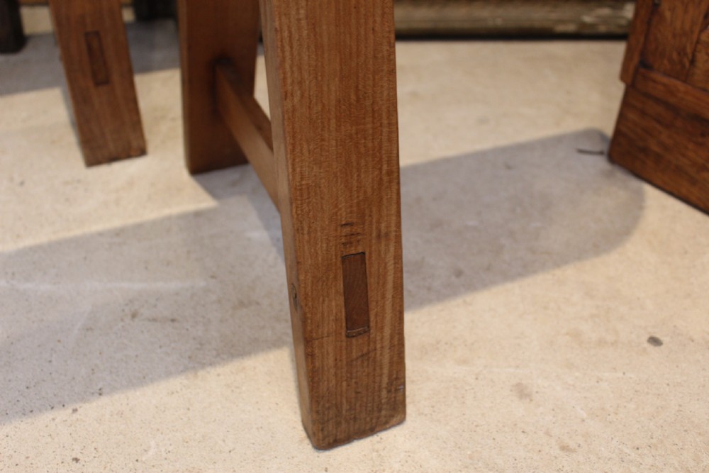 A pair of long 19th-century French fruitwood refectory benches featuring A-frame trestle legs and pegged joinery. View III
