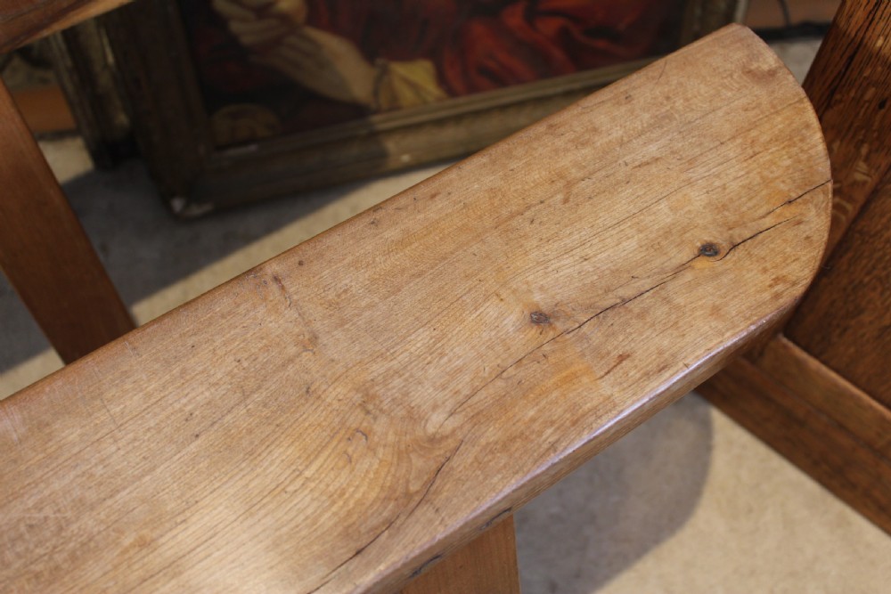 A pair of long 19th-century French fruitwood refectory benches featuring A-frame trestle legs and pegged joinery. View IV