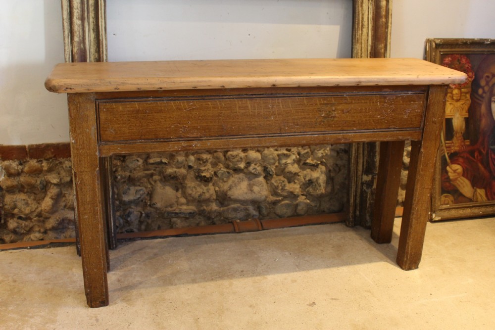 A Victorian wooden console table featuring a light pine top set upon a dark oak frame with square legs.