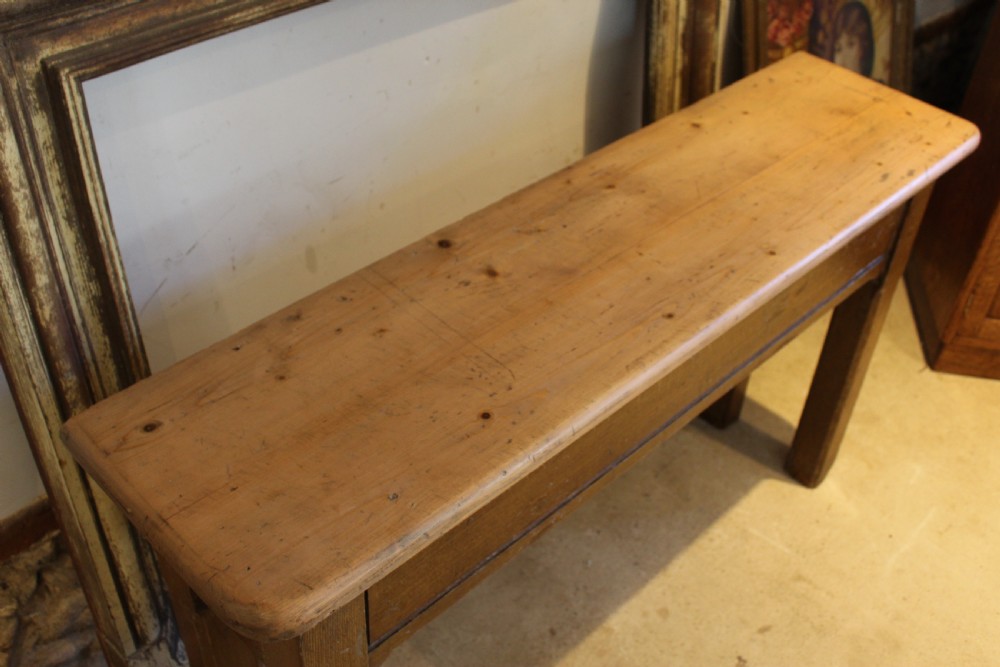 A Victorian wooden console table featuring a light pine top set upon a dark oak frame with square legs. View VI