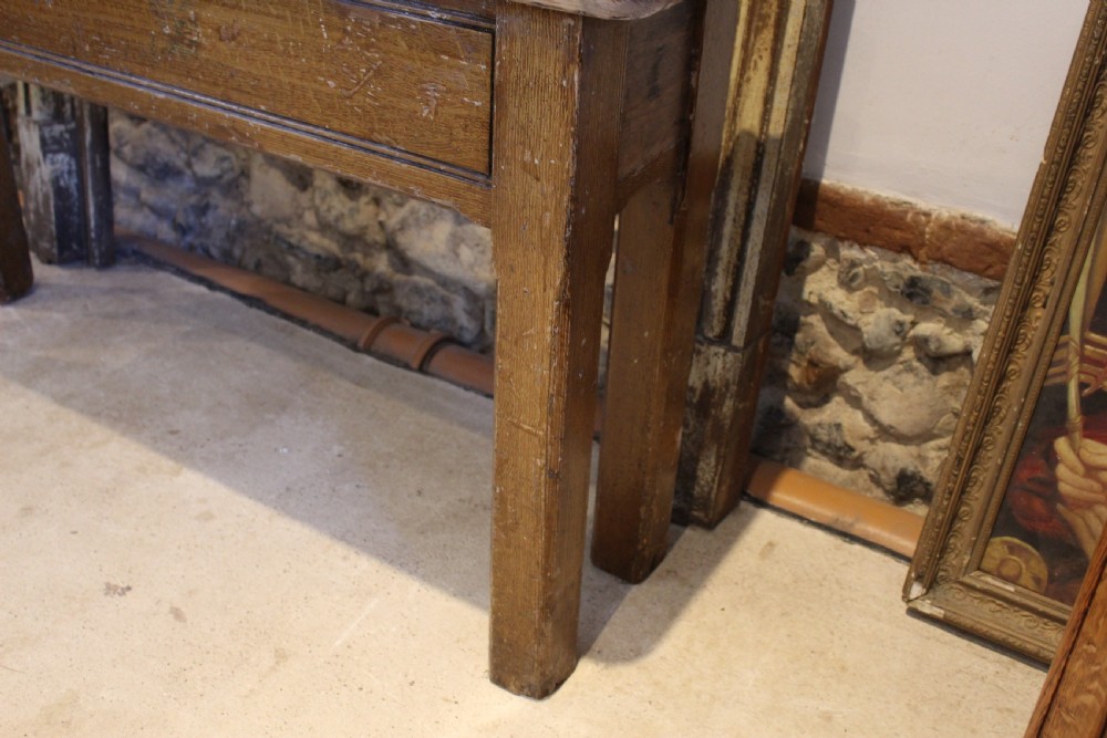 A Victorian wooden console table featuring a light pine top set upon a dark oak frame with square legs. View IX