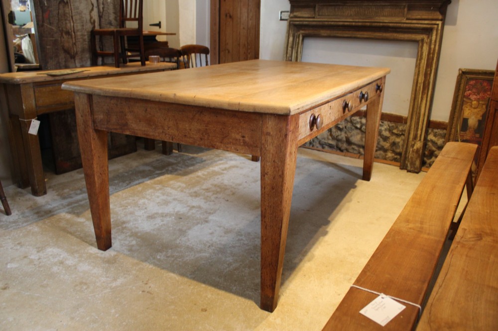 A late Victorian oak farmhouse dining table featuring a plain rectangular top, frieze drawers with wooden turned knobs, and square tapered legs. View III