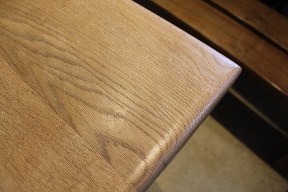 A late Victorian oak farmhouse dining table featuring a plain rectangular top, frieze drawers with wooden turned knobs, and square tapered legs. View VI
