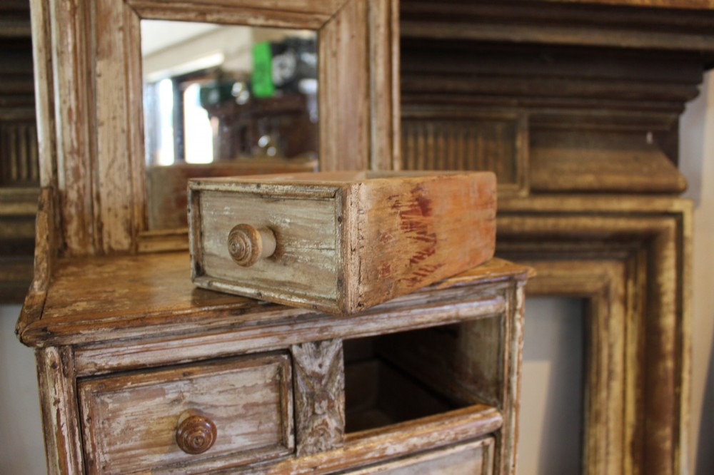 A late 19th-century French miniature wooden chest of drawers featuring a painted distressed cream finish, small turned wooden knobs, and an attached swivel mirror. View VII