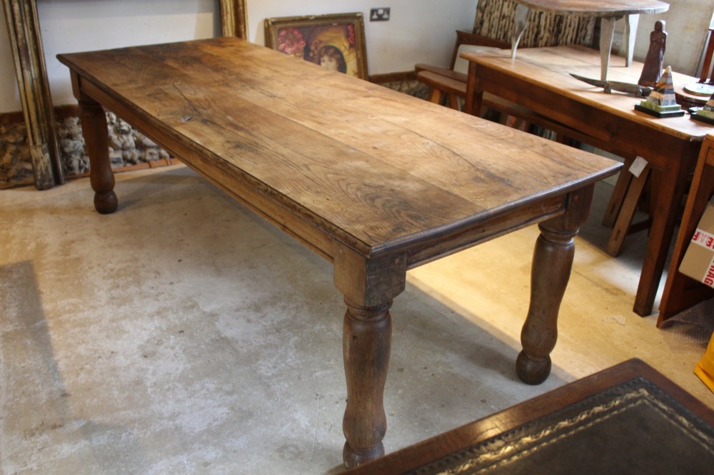 A large Edwardian oak refectory dining table with a rectangular plank top and sturdy turned legs. View III