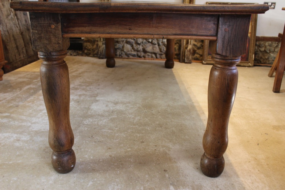 A large Edwardian oak refectory dining table with a rectangular plank top and sturdy turned legs. View VIII