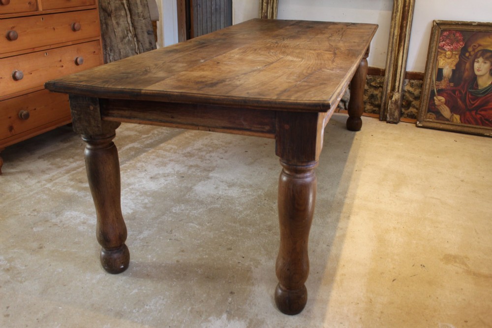 A large Edwardian oak refectory dining table with a rectangular plank top and sturdy turned legs. View IX