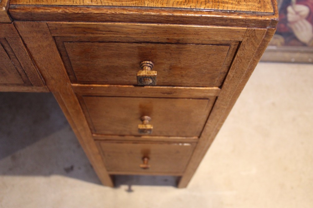 An antique golden oak dressing table featuring a central flip-top section, side drawer pedestals, and square wooden handles. View IV