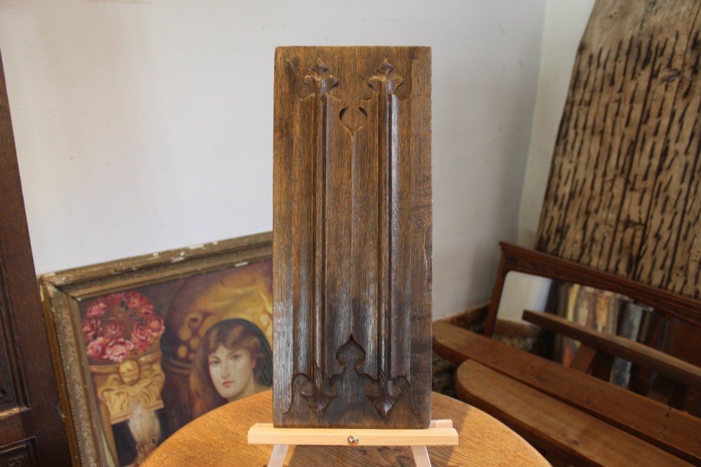 A collection of 16th and 17th-century carved oak panels displaying intricate linenfold and Gothic tracery relief motifs in dark brown tones. View VII